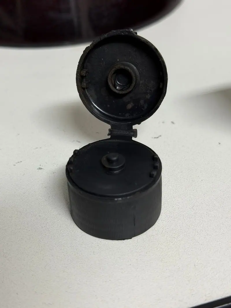 Plastic part injected from the mold for a flip top cap — detail 2
